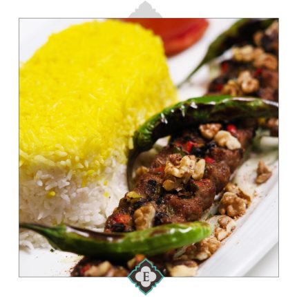 Traditional kebab from delicious mix of minced beef, lamb and vegetables served with fresh vegetables and barbecued tomato
