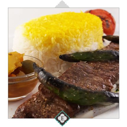 A skewer of beef tenderloin & fillet barbequed & served with barbequed tomatoes & sides